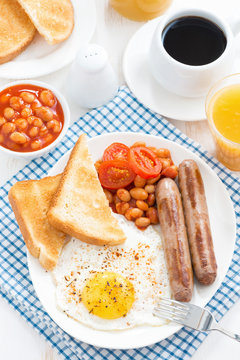 traditional English breakfast with sausages, vertical, top view