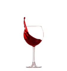Red wine splashing from glass, isolated on white background