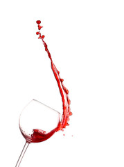 Red wine splashing from glass, isolated on white background