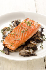 grilled salmon fillet with mushroom on a plate