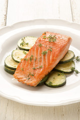 grilled salmon fillet with zucchini on a plate
