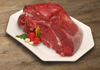 Raw meat selection on wooden cutting board with knife