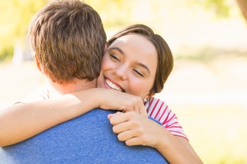 Fototapeta premium Cute couple hugging in the park