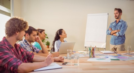 Casual businessman giving presentation to his colleagues