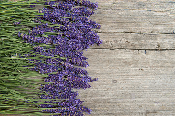 Lavender flowers on wooden background. Fresh blossoms
