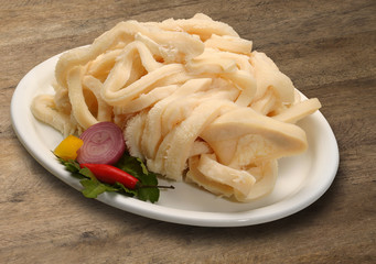 Raw meat selection on wooden cutting board with knife