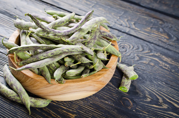 Green fresh soybeans on wood background