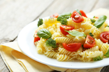 Delicious pasta on plate on grey wooden background