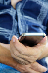 older man checking his phone background