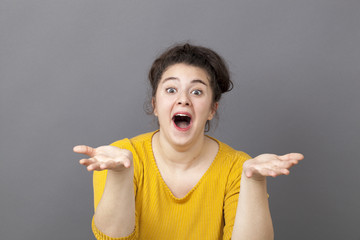 funny beautiful overweight girl laughing with euphoric smile and playful hands in foreground...