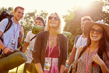 Group Of Young People Going Camping At Music Festival