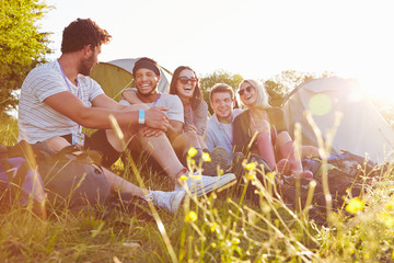 Fototapeta premium Group Of Friends Relaxing Outside Tents On Camping Holiday