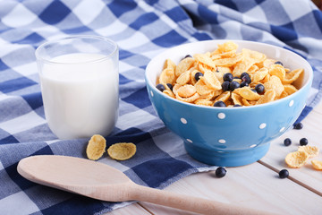 cornflakes with bilberry, milk cup and spoon