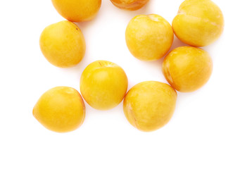Pile of multiple yellow plums isolated