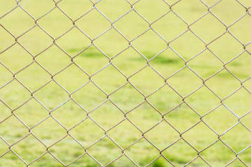 Fototapeta premium iron wire fence on green background