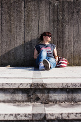 Woman sitting on a pavement on a hot summer day