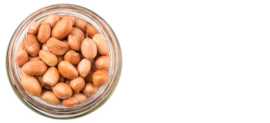 Peanuts or ground nuts in a mason jar over white background