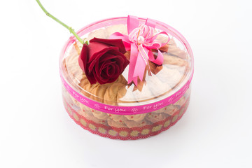 cookie and rose on white background