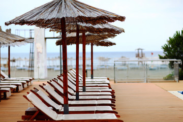 Beach umbrellas at the hotel lounge chairs