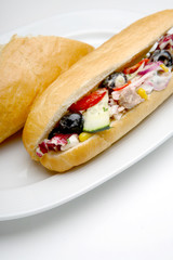 Sandwich with vegetables and ham on the plate, isolated on white, close up studio shot