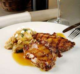 Grilled steak on a plate with mashed potatoes