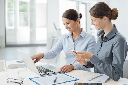 Business women working together on a laptop