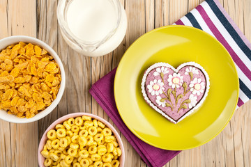 Decoration gringerbread heart, corn flakes and milk