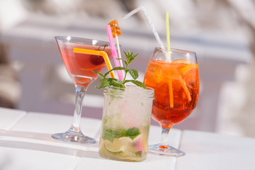 Three refreshing  summer cocktails at a beach bar