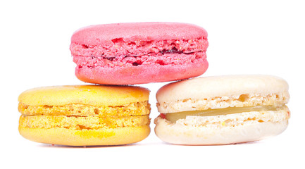 Triangle pile of colorful french macaroons dessert on white bak