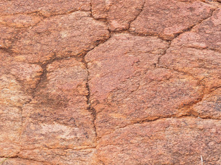 Background close-up of orange red dolomite rock with pitting and cracks near Alice Springs, red center, Australia June 2015