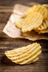 Potato chips on wooden table