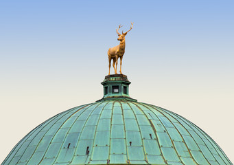 Fototapeta na wymiar Stuttgart, Germany: golden deer sculpture (early XIX century) on the Palace of Arts dome at Schlossplatz