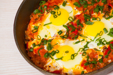 eggs with vegetables in a frying pan