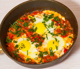 eggs with vegetables in a frying pan