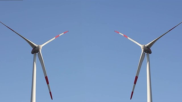 Two Large Wind Turbines. Mirror. 
