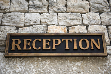 Reception sign on the stone wall