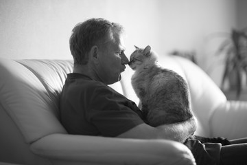 Profile of an elderly man and a cat arguing