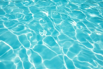Naklejka na ściany i meble Blue water surface in swimming pool