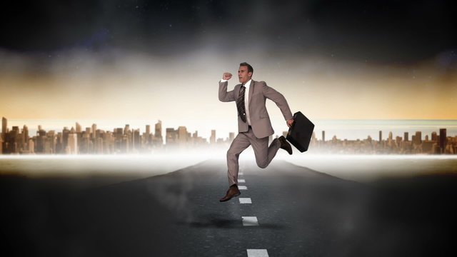 Businessman jumping with city on background