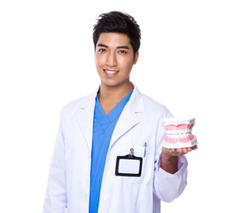 Dentist holding with denture