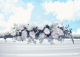 Wedding floral decorations, gentle white flowers over blue sky b