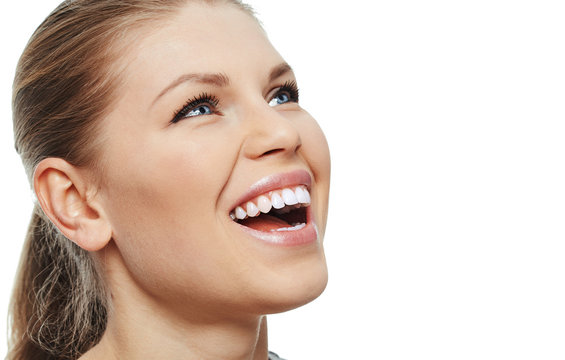 Teeth whitening and treatment. Close-up of pretty girl with toothy smile 