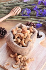 Roasted cashews nuts with natural on wood background