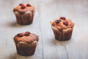 Muffins on a wooden table covered with sugar. Shallow depth of field.
