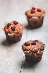 Muffins on a wooden table covered with sugar. Shallow depth of field.
