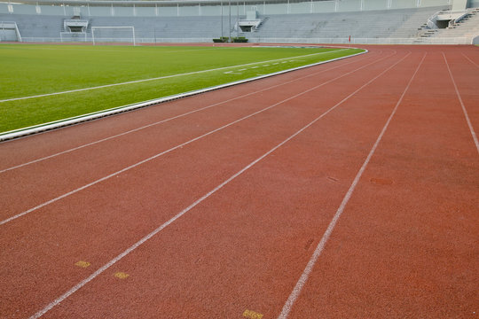 Running track with lawn yard for the athletes background