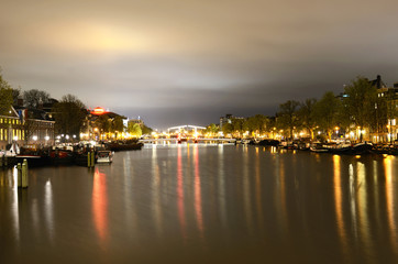 Obraz premium View of the night channel bridge in illumination and boats in Am