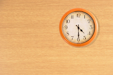 Clock showing 4:30 o'clock on a wooden wall