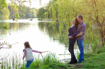 family dad mother and daughter on a walk on nature