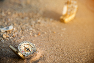 Fototapeta na wymiar Retro compass on the beach, vintage style